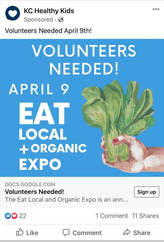 A Facebook Ad from KC Healthy Kids that includes an image with a blue background, white text and a picture of a woman's hand holding lettuce, and reads "Volunteers needed! April 9, Eat Local + Organic Expo" with a call-to-action to sign up