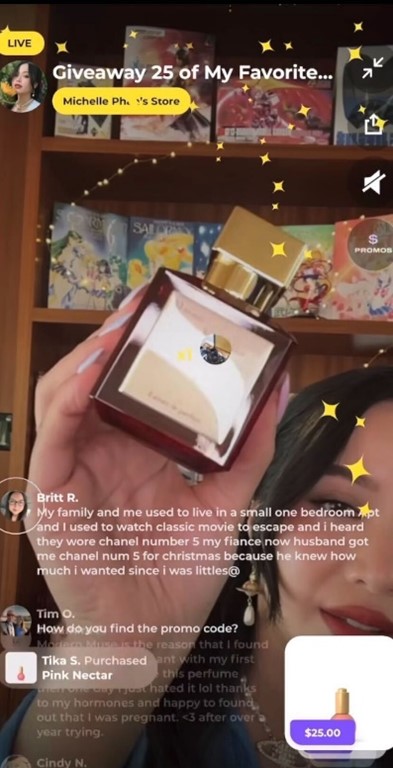 Screen capture of a perfume giveaway on Popshop Live. Woman holding a perfume bottle in front of camera with comments from viewers.